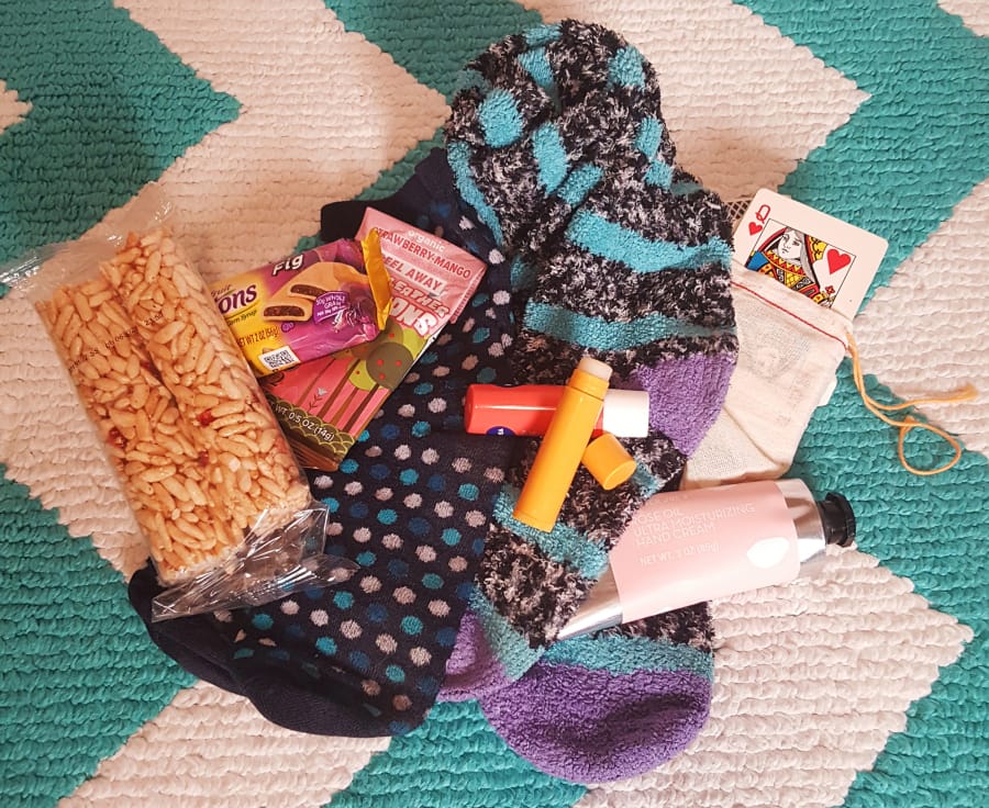 Just a few small things can make a big difference: snacks, warm socks, lip balm, lotion and a deck of cards can make the hours pass more easily.