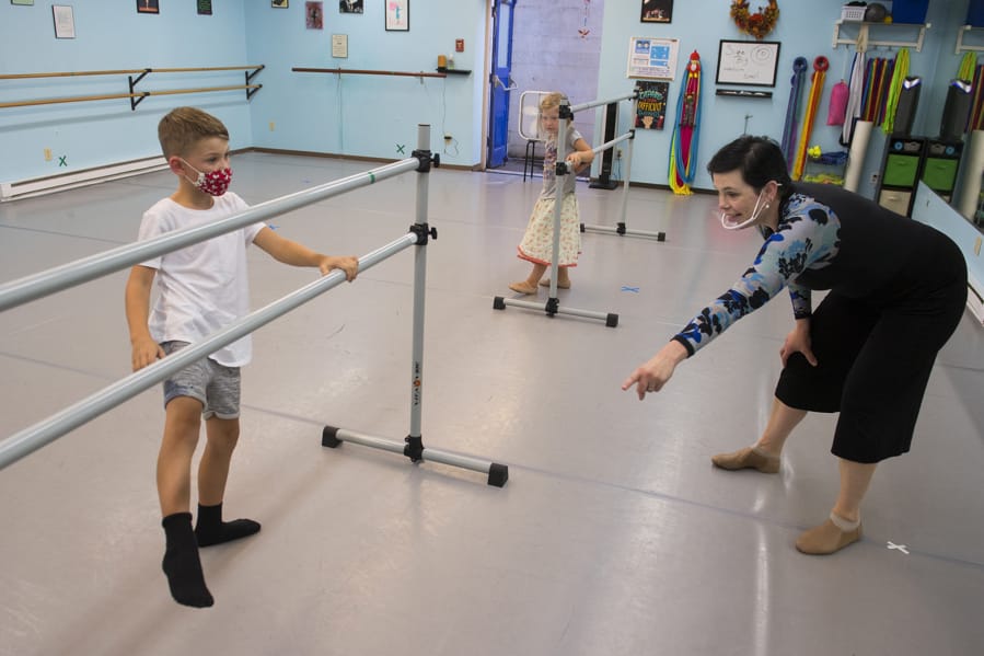 Jeremiah Andryushin, 7, of Vancouver, from left, gets some help with his footwork while joined by his sister, Ada, 4, from dance instructor Liz Borromeo at Liz Borromeo Dance. Borromeo teaches small classes while others join in on Zoom, a platform she hopes to abandon when the pandemic is over. &quot;Zoom is great, I think, for lectures, but it&#039;s a challenging platform for dance,&quot; she said. &quot;The day I get to delete my Zoom account will be a glorious day.