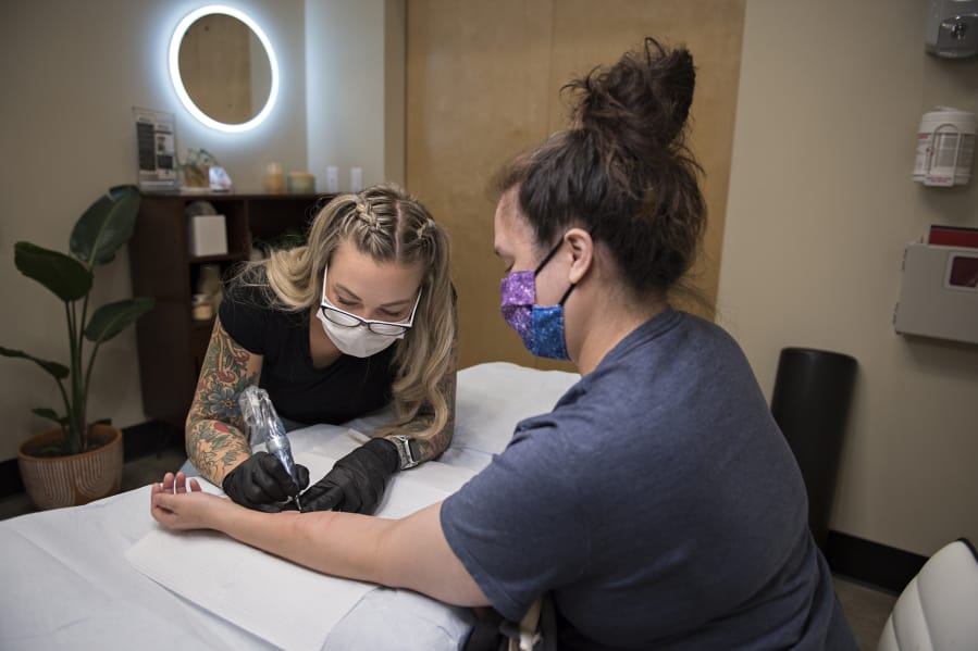 Lina Anderson of Studio Meraki works with Gwen McClellan of Vancouver as she gets the first of two scar camouflage treatments in Portland. They are self-harm scars from her teenage years. Anderson has used the camouflage treatment to help people with self-harm scars.