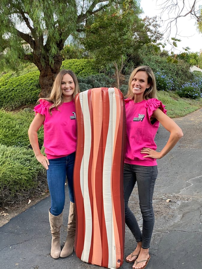 Teammates Lois Arbogast and Julia Warren, a 2003 Skyview High School graduate, pose with a giant inflatable likeness of bacon. They compete on the reboot of &quot;Supermarket Sweep,&quot; which premieres at 8 p.m. Sunday on ABC.