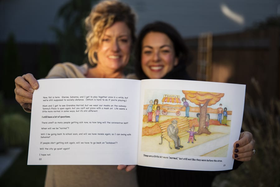 Illustrator Julie Dee, left, and author Solina Adelson-Journey are pictured with their book, &quot;When the City Went Quiet,&quot; in Vancouver. The friends collaborated on a children&#039;s book about the coronavirus pandemic.