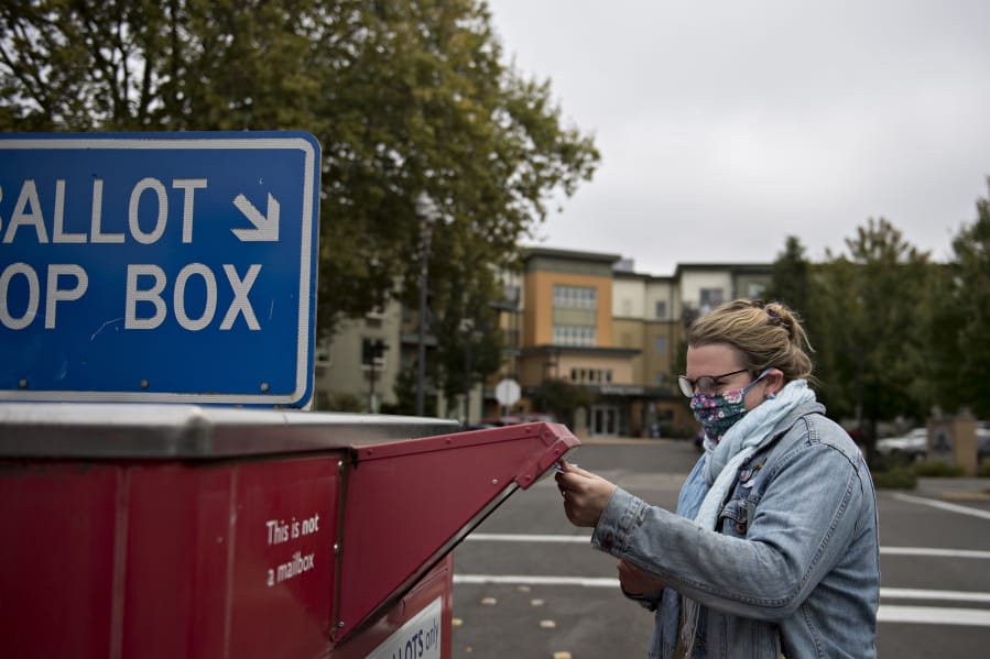 Sydney Bardurian of Vancouver makes sure her vote counts by swinging by the downtown ballot drop-off box Thursday afternoon.