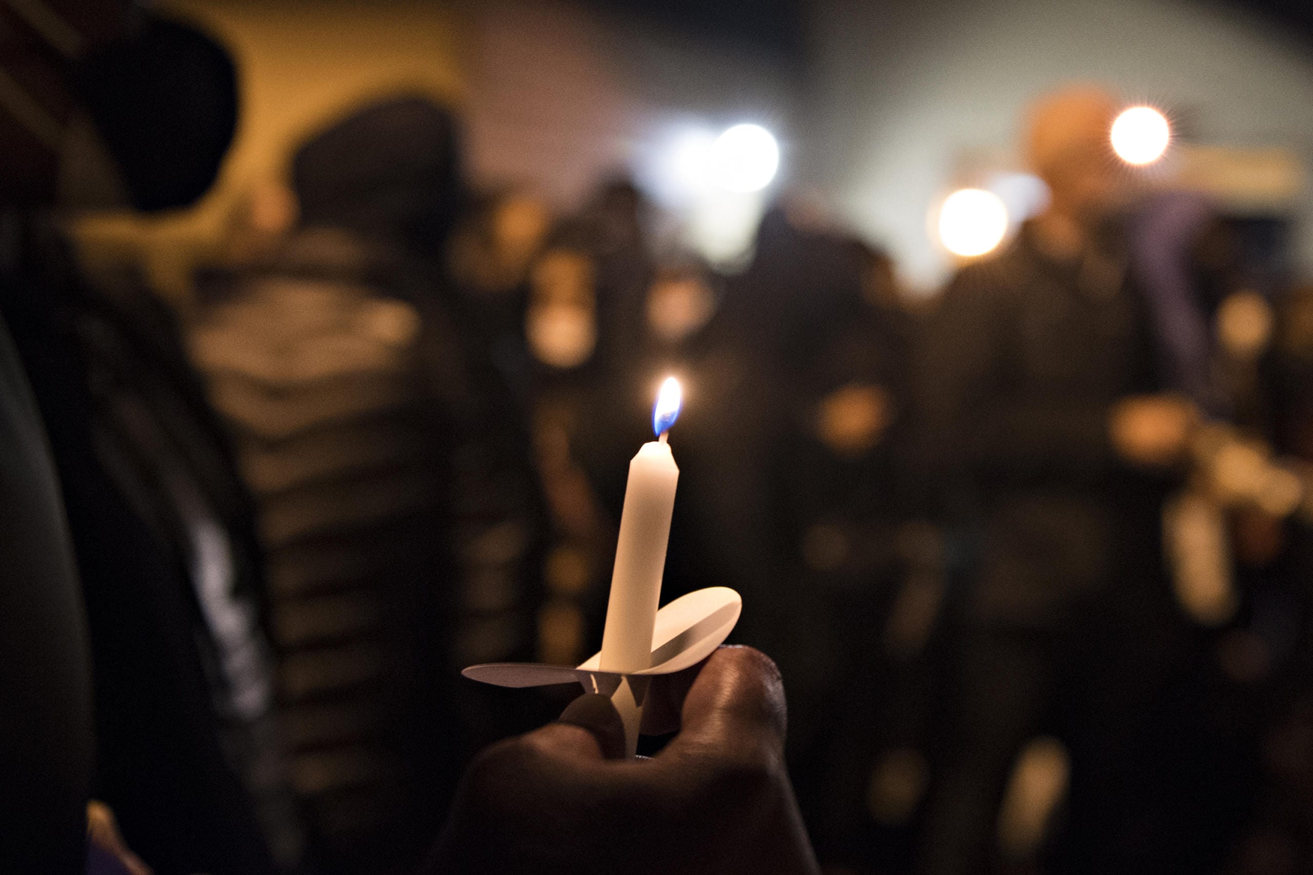 Mourners pay their respects as Kevin Peterson Jr., a 21-year-old Black Camas man, is remembered with a candlelight vigil at the Hazel Dell branch of U.S. Bank on Friday night, Oct. 30, 2020.