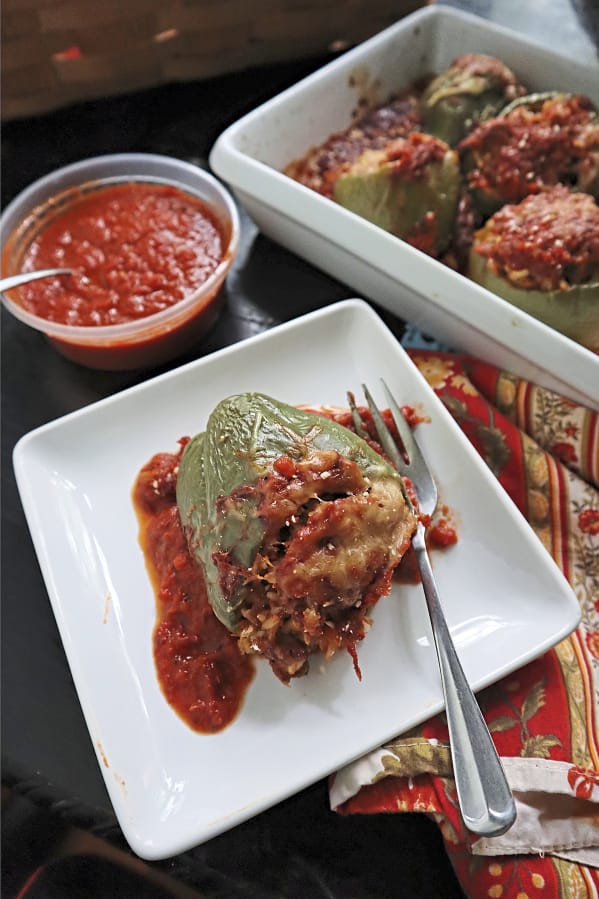 Bell peppers stuffed with a cheesy mixture of sweet Italian sausage, brown rice and Parmesan cheese make a hearty fall meal.