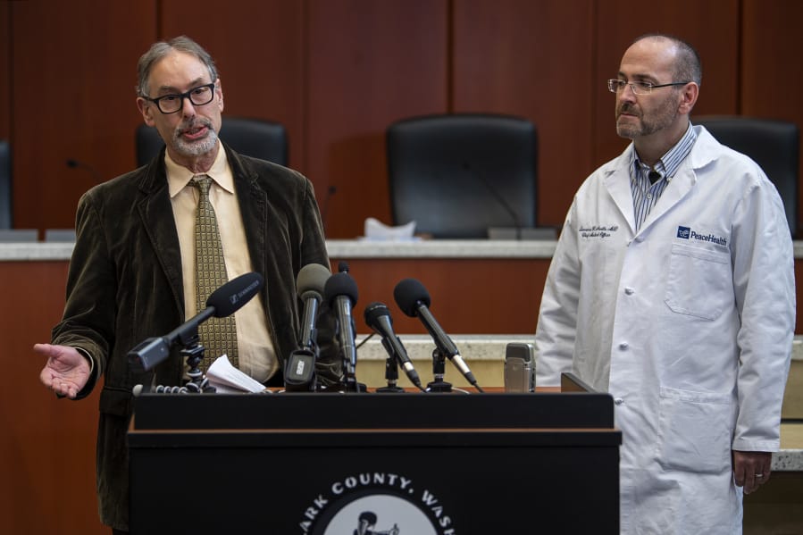 Clark County Public Health Officer Dr. Alan Melnick, left, and Dr. Lawrence Neville, chief medical officer at PeaceHealth Southwest, speak March 13 during a COVID-19 press conference at the Clark County Public Service Center. Seven months later, the pandemic is no closer to being over.