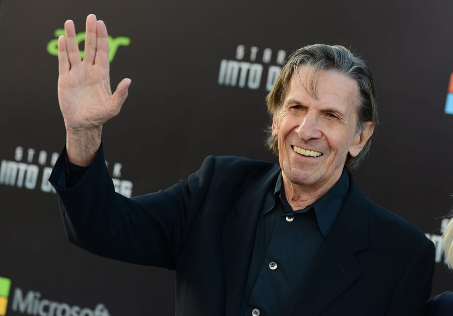 The late Leonard  Nimoy flashes the Vulcan Salute as he arrives for a &quot;Star Trek&quot; movie premiere on May 14, 2013, in Los Angeles.