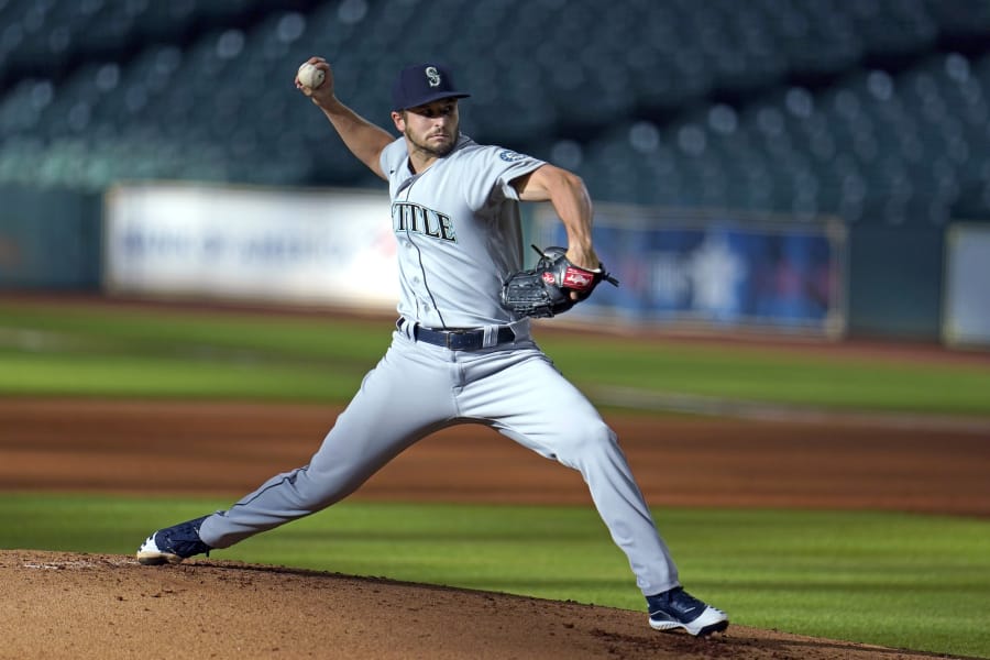 FILE - In this July 27, 2020, file photo, Seattle Mariners starting pitcher Kendall Graveman throws to a Houston Astros batter during the first inning of a baseball game in Houston. Graveman and the Mariners agreed to a $1.25 million one-year contract Thursday, Oct. 29, after the team declined his $3.5 million option in favor of a $500,000 buyout. Graveman agreed last year to a $2 million deal that included a $1.5 million salary for 2020 plus the option year. He earned $555,556 in prorated pay. (AP Photo/David J.
