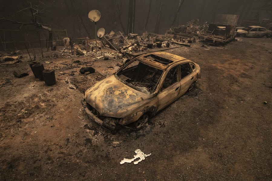 A burned vehicle sits in front of a home on Oro Quincy Hwy. destroyed in the North Complex fire on Friday, Sept. 11, 2020 in Berry Creek, California.