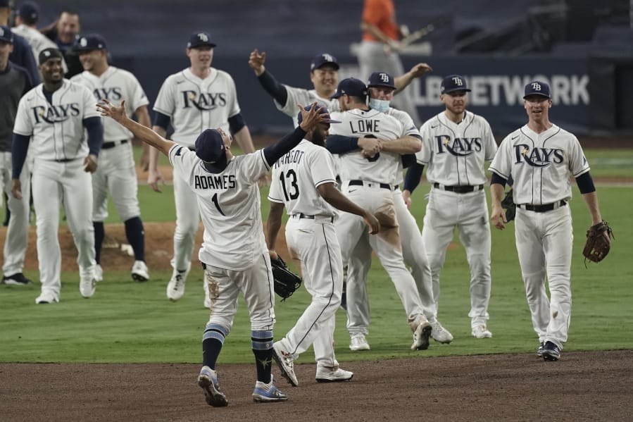Tampa Bay Rays celebrate their victory against the Houston Astros in Game 7 of a baseball American League Championship Series, Saturday, Oct. 17, 2020, in San Diego. The Rays defeated the Astros 4-2 to win the series 4-3 games.(AP Photo/Jae C.