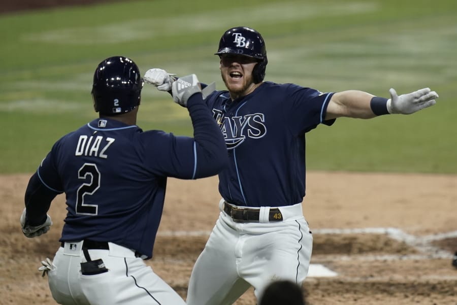 Tampa Bay Rays&#039; Michael Brosseau, right, celebrates with Yandy Diaz after hitting a solo home run during the eighth inning in Game 5 of a baseball American League Division Series against the New York Yankees, Friday, Oct. 9, 2020, in San Diego. (AP Photo/Jae C.