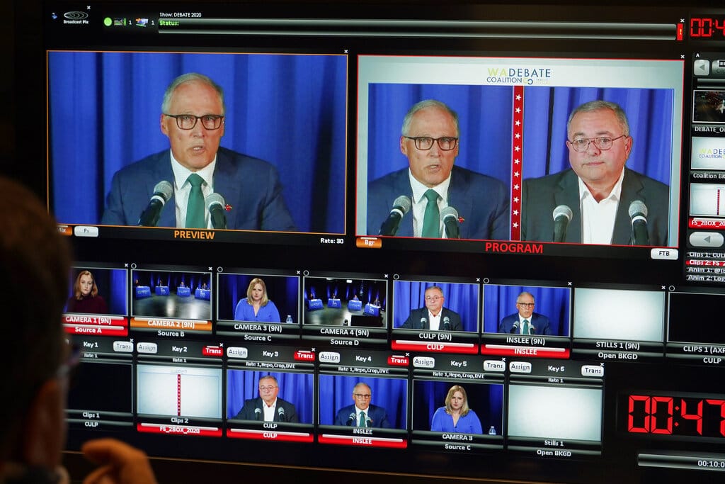Washington gubernatorial candidates Gov. Jay Inslee, a Democrat, left, and Loren Culp, a Republican, right, are shown on a monitor in a video control room at the studios of TVW, Wednesday, Oct. 7, 2020, in Olympia, Wash., as they take part in a debate. Due to concerns over COVID-19, each candidate took part in the debate from individual rooms separate from moderators. (AP Photo/Ted S.