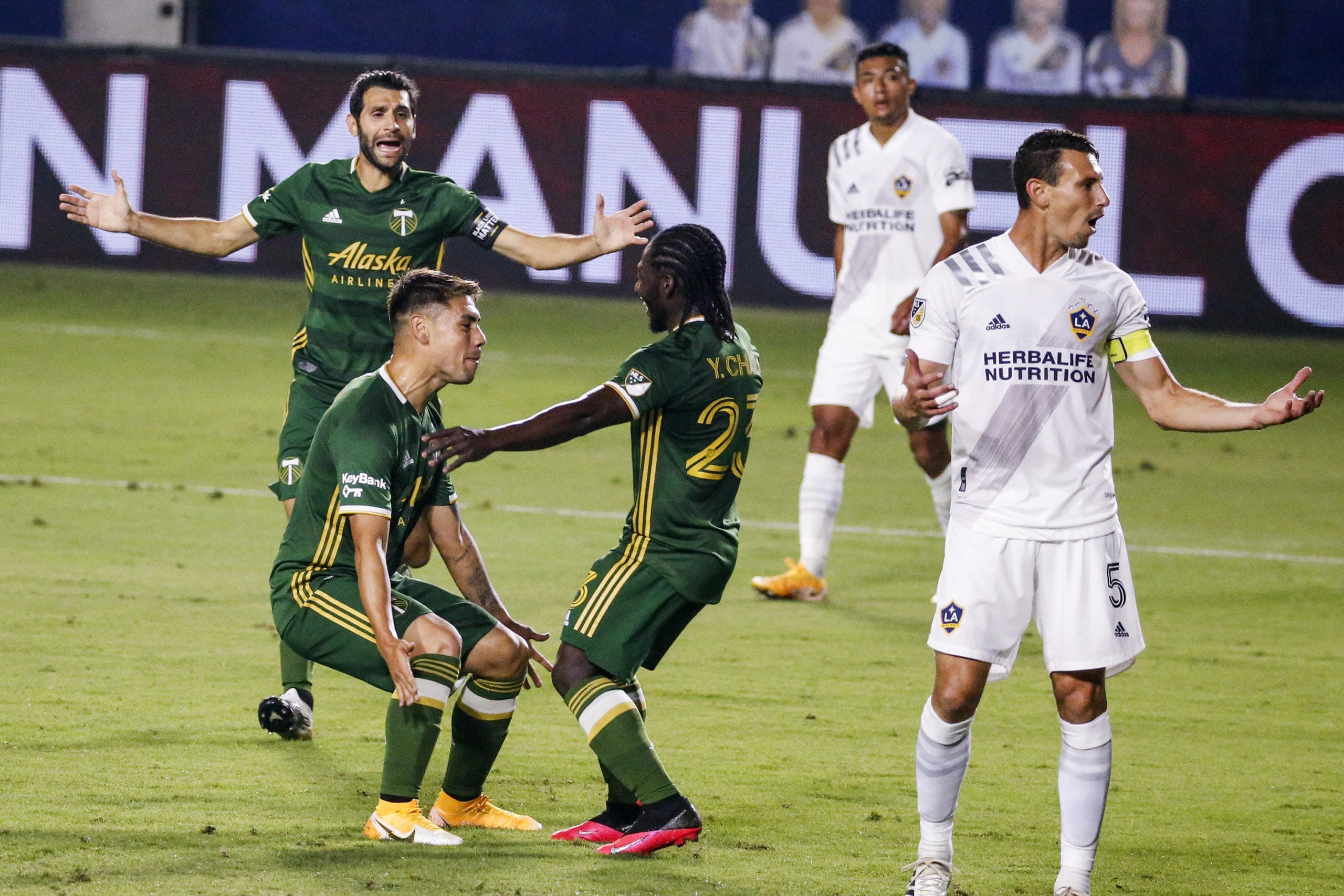Portland Timbers forward Felipe Mora, front left, celebrates with midfielder Yimmi Chara, center, after scoring a goal against the LA Galaxy during the first half of an MLS soccer match in Carson, Calif., Wednesday, Oct. 7, 2020. (AP Photo/Ringo H.W.