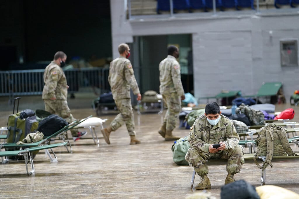 Members of the Louisiana National Guard prepare beds in a shelter ahead of Hurricane Delta, Friday, Oct. 9, 2020, in Lake Charles, La. Forecasters said Delta — the 25th named storm of an unprecedented Atlantic hurricane season — would likely crash ashore Friday evening somewhere on southwest Louisiana's coast.