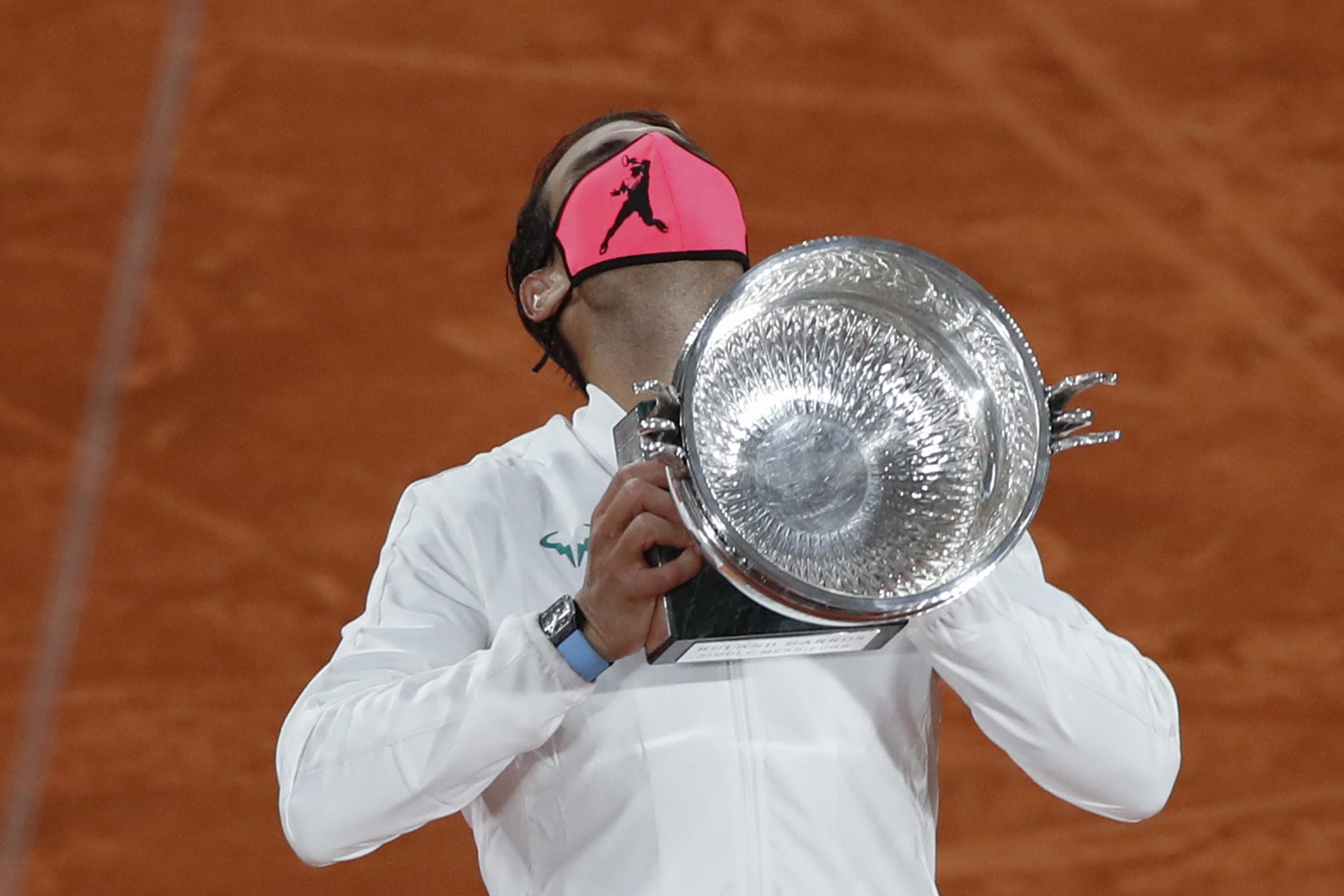 Spain's Rafael Nadal holds the trophy as he celebrates winning the final match of the French Open tennis tournament against Serbia's Novak Djokovic in three sets, 6-0, 6-2, 7-5, at the Roland Garros stadium in Paris, France, Sunday, Oct. 11, 2020.