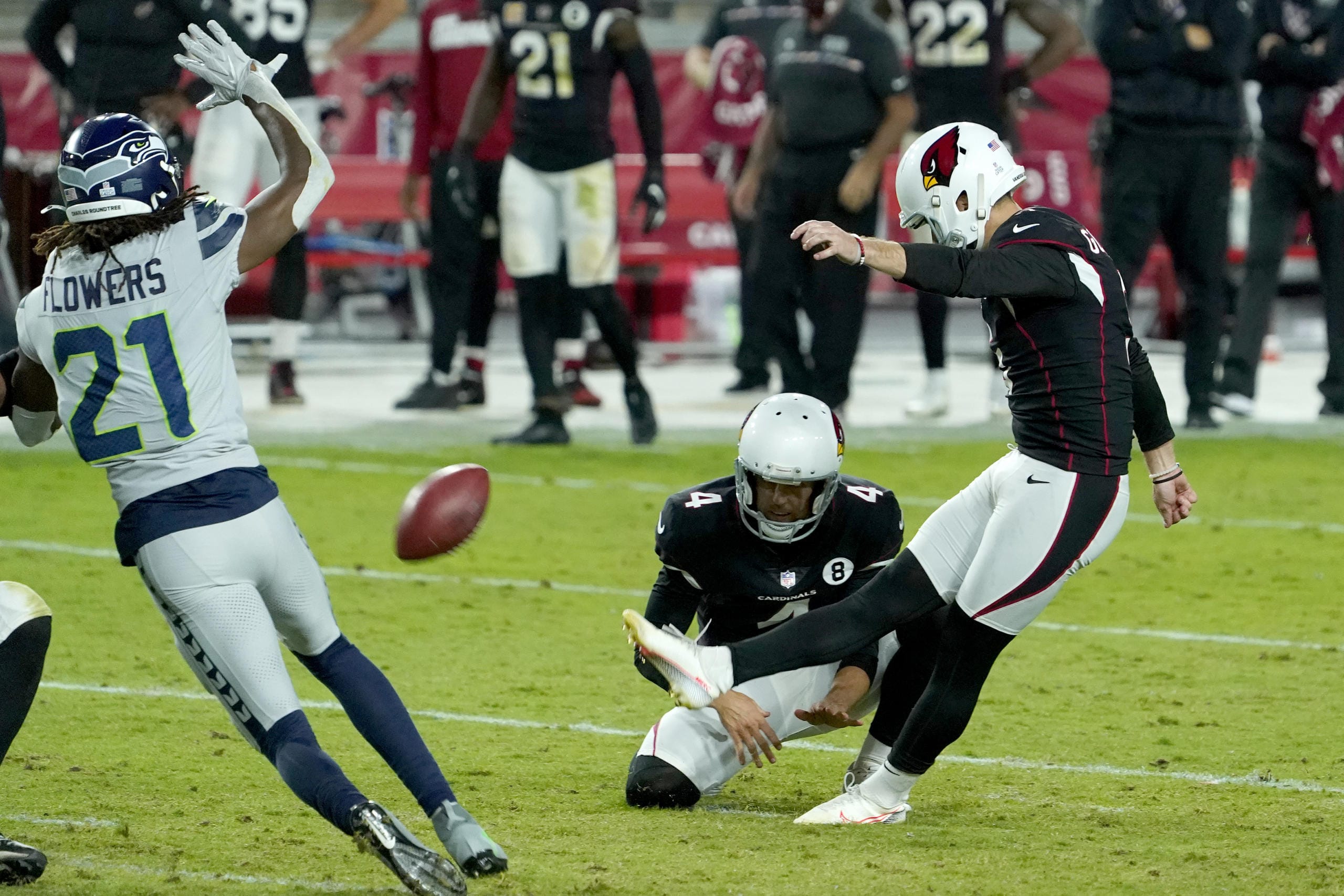Arizona Cardinals kicker Zane Gonzalez kicks the game winning field goal as punter Andy Lee (4) holds during the second half of an NFL football game against the Seattle Seahawks, Sunday, Oct. 25, 2020, in Glendale, Ariz. The Cardinals won 37-34 in overtime.