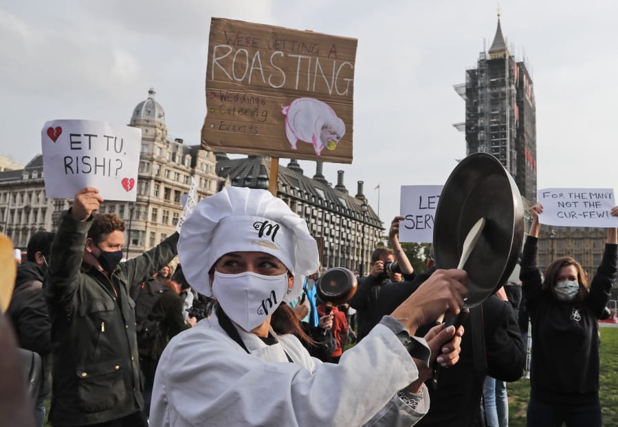 Hospitality workers protest in Parliament Square in London, Monday, Oct. 19, 2020.