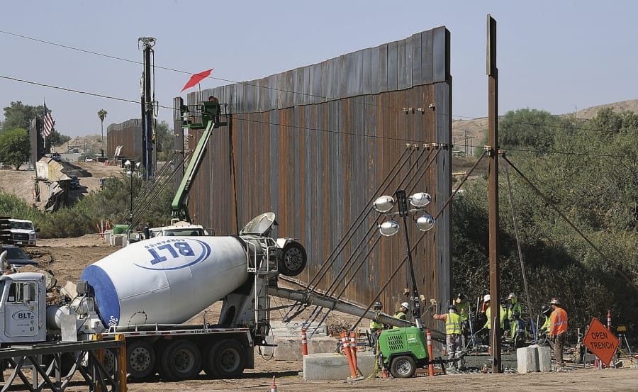 More sections of the 30-foot high &quot;bollard style wall&quot; between the United States and Mexico are seen being constructed heading west from the Yuma Levee Road, in the proximity of County 8th Street, in the direction of the Colorado River, Thursday, Oct. 15, 2020 in Yuma, Ariz.. In the background is the U.S. Port of Entry at Andrade, Calif., where additional sections of the wall are seen being constructed.