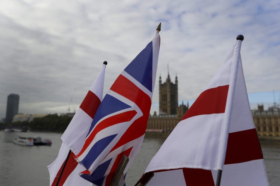 English flags and a Union flag fly above a souvenir stand opposite Britain&#039;s Parliament in London, Friday, Oct. 16, 2020. Britain&#039;s foreign minister says there are only narrow differences remaining in trade talks between the U.K. and the European Union. But Dominic Raab insists the bloc must show more &quot;flexibility&quot; if it wants to make a deal.