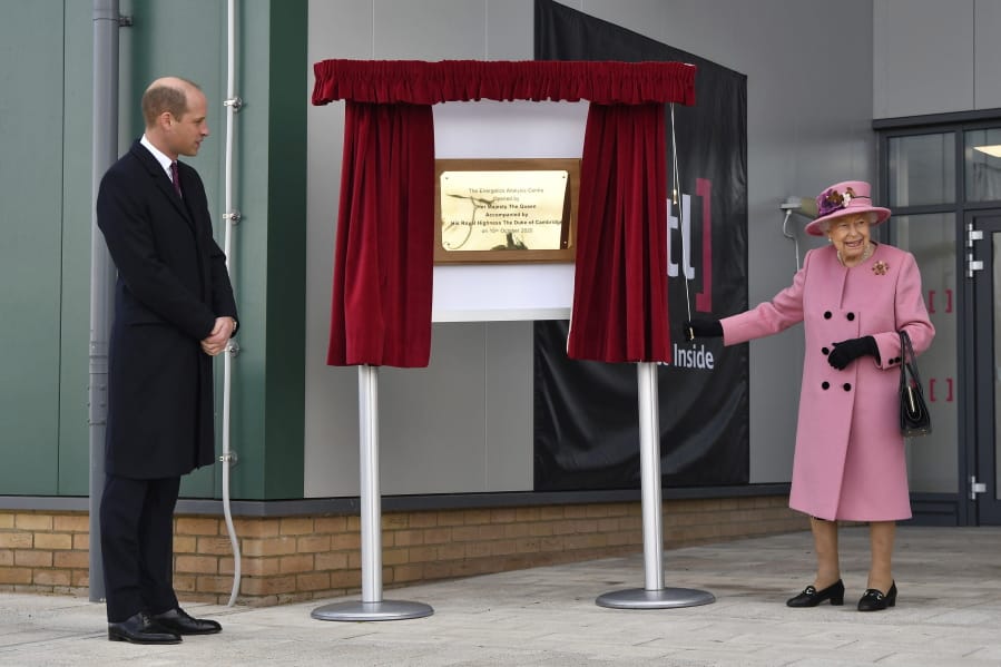 Britain&#039;s Prince William looks on as Queen Elizabeth II unveils a plaque to open the new Energetics Analysis Centre at the Defence Science and Technology Laboratory on Thursday at Porton Down, England.