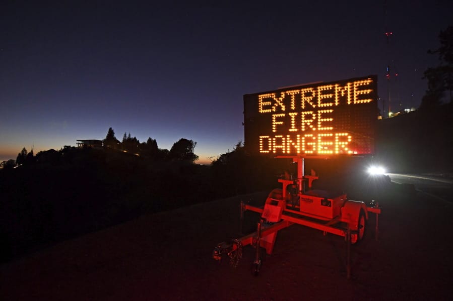 A roadside sign warns motorists of extreme fire danger on Grizzly Peak Boulevard, in Oakland, Calif., Sunday, Oct. 25, 2020. Due to high winds and dry conditions PG&amp;E will turn off the power to over 361,000 customers in 36 counties to protect them from possible wildfires caused by downed power lines. The National Weather Service predicts offshore winds from the north peaking at higher elevations up to 70 mph.