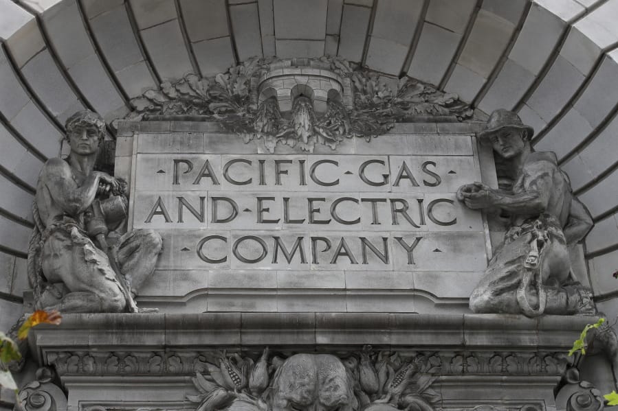 FILE - In this April 16, 2020, file photo, a Pacific Gas &amp; Electric sign is displayed on the exterior of a PG&amp;E building in San Francisco. Pacific Gas &amp; Electric will cut power to over 1 million people on Sunday to prevent the chance of sparking wildfires as extreme fire weather returns to the region, the utility announced Friday, Oct. 23, 2020.