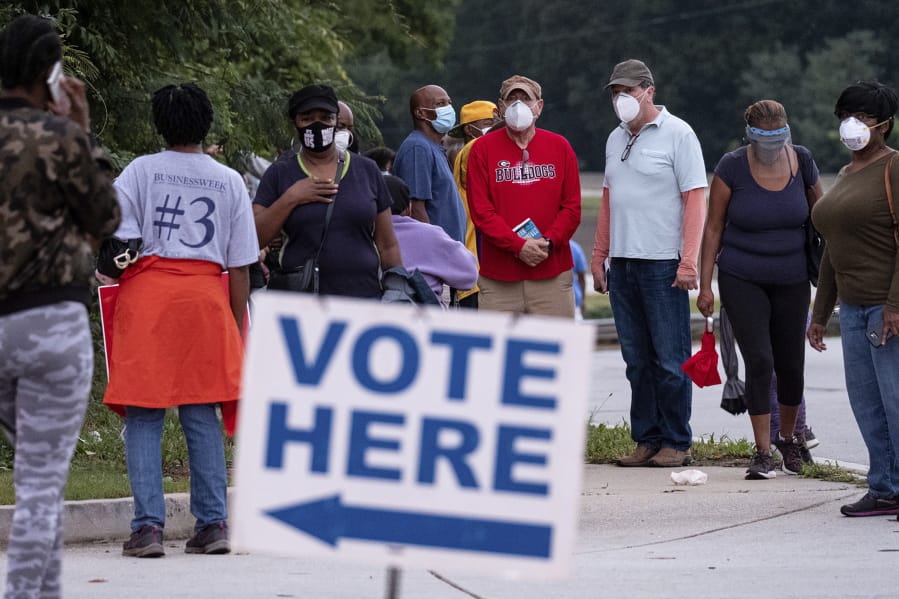 People wait in line to vote in Decatur, Ga., Monday, Oct. 12, 2020.