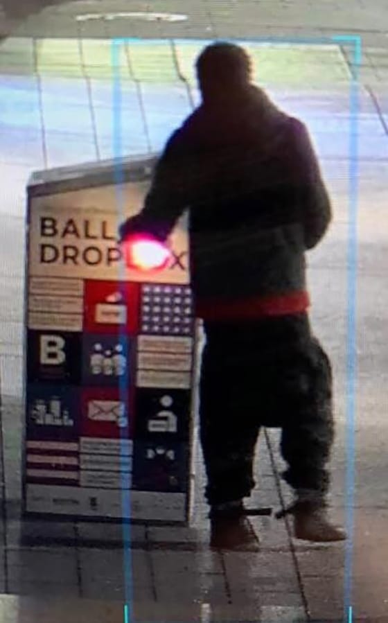 This surveillance image provided by the Boston Police Department shows a man approaching a ballot drop box outside the Boston Public Library, early Sunday, Oct. 25, 2020, in downtown Boston. Massachusetts election officials say a fire was set at the ballot drop box holding more than 120 ballots in what appears to have been a &quot;deliberate attack.&quot; Boston Police say that an arson investigation is underway and the person shown in this surveillance image is a person of interest.