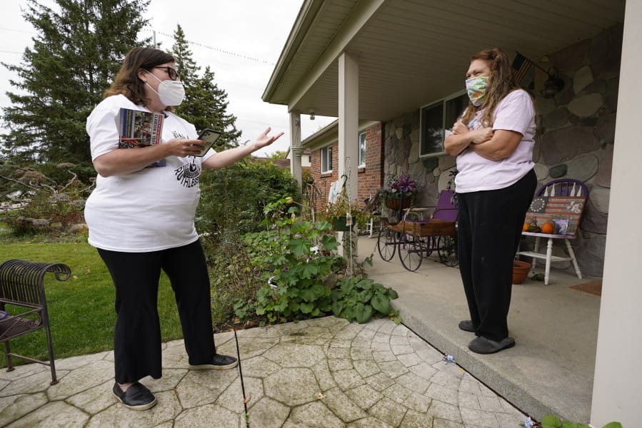 Lori Goldman, talks with a voter while canvassing in Troy, Mich., Thursday, Oct. 15, 2020. Goldman spends every day door knocking for Democrats in Oakland County, an affluent Detroit suburb. She feels responsible for the country&#039;s future: Trump won Michigan in 2016 by 10,700 votes and that helped usher him into the White House. Goldman believes people like her -- suburban white women -- could deliver the country from another four years of chaos.