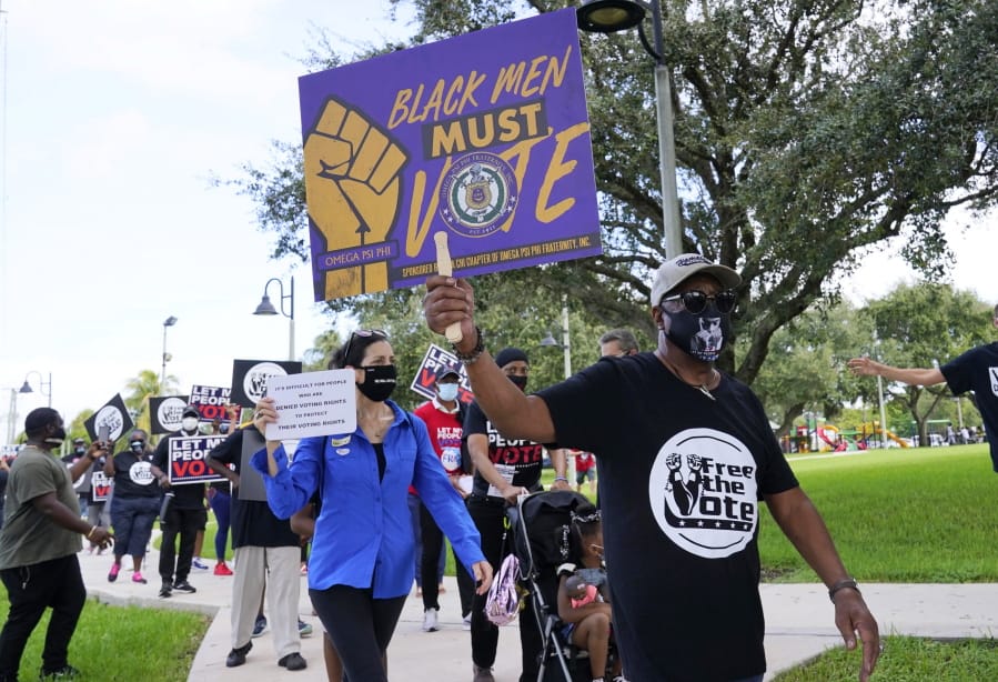 Supporters of restoring Florida felons&#039; voting rights march to an early voting precinct, Saturday, Oct. 24, 2020, in Fort Lauderdale, Fla. The Florida Rights Restoration Coalition led marches to the polls in dozens of Florida counties.