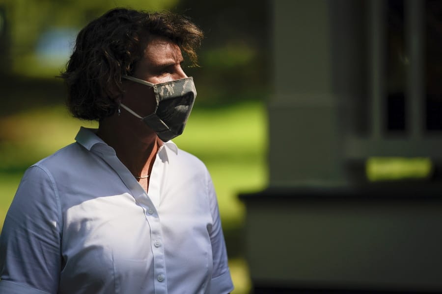 FILE - In this Aug. 25, 2020 file photo, U.S. Senate candidate Amy McGrath wears a face mask as she holds a rally with supporters during a campaign stop at Woodland Park in Lexington, Ky. Amy McGrath will face U.S. Senate Majority Leader Mitch McConnell on Election Day in November.