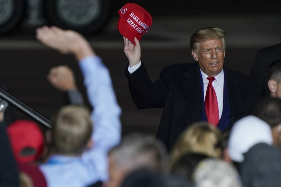 President Donald Trump throws a hat to the crowd after speaking at a campaign rally at the Central Wisconsin Airport Thursday, Sept. 17, 2020, in Mosinee, Wis.
