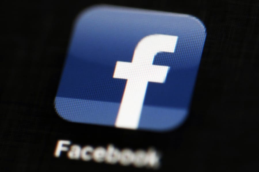 FILE - This May 16, 2012 file photo shows the Facebook app logo on a mobile device in Philadelphia. On Monday, Oct. 12, 2020, Facebook announced it is banning posts that deny or distort the Holocaust and will start directing people to authoritative sources if they search for information about the Nazi genocide.
