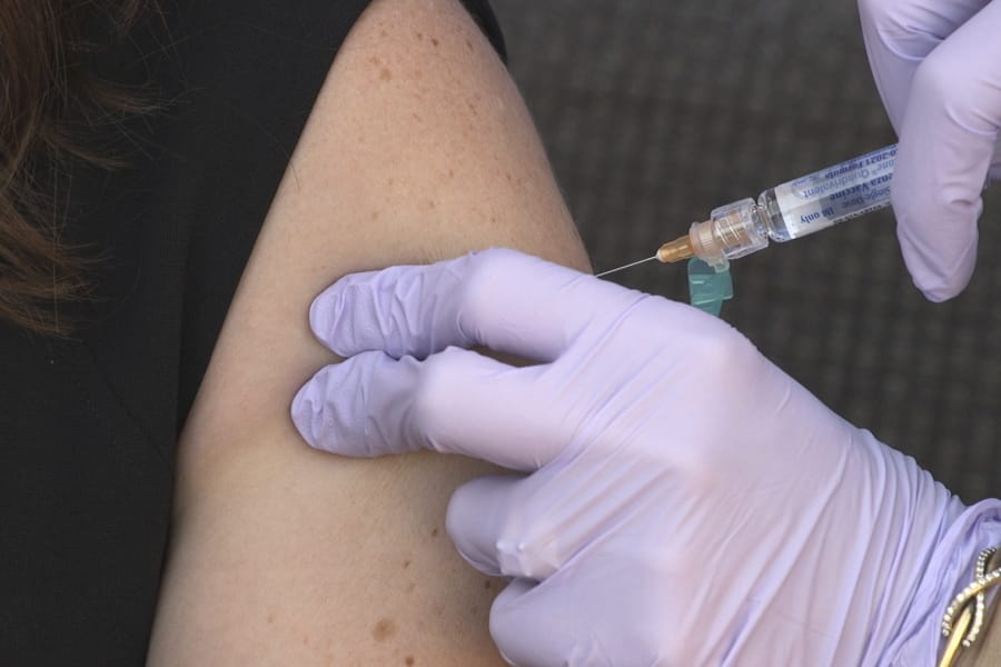 A flu vaccine is administered to National Foundation for Infectious Diseases (NFID) staff members in Bethesda, Md., on Wednesday, Sept. 30, 2020.
