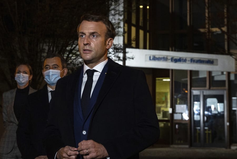 French President Emmanuel Macron, flanked by French Interior Minister Gerald Darmanin, second left, speaks in front of a high school Friday Oct.16, 2020 in Conflans Sainte-Honorine, northwest of Paris, after a history teacher who opened a discussion with high school students on caricatures of Islam&#039;s Prophet Muhammad was beheaded. French President Emmanuel Macron denounced what he called an &quot;Islamist terrorist attack&quot; against a history teacher decapitated in a Paris suburb Friday, urging the nation to stand united against extremism.
