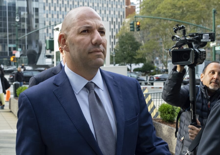FILE- In this Oct. 17, 2019 file photo, David Correia walks from federal court in New York. Correia and his business partner Lev Parnas, were charged with defrauding investors in a business called &quot;Fraud Guarantee.&quot; On Thursday, Sept. 17, 2020 a superseding indictment brought by federal prosecutors also charged them with additional campaign finance violations.