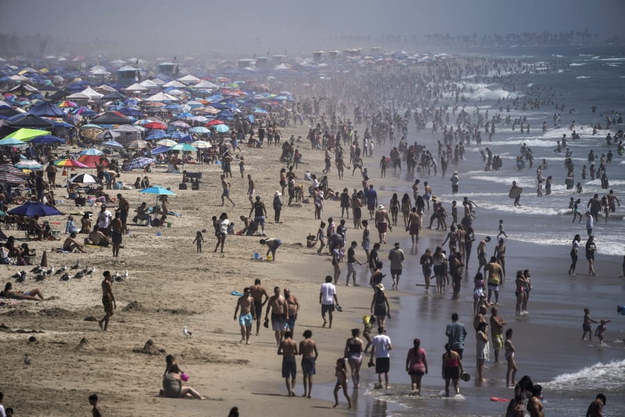 FILE - In this Saturday, Sept. 5, 2020 file photo, people crowd the beach in Huntington Beach, Calif., as the state swelters under a heat wave. On Wednesday, Oct. 14, 2020, the U.S. National Oceanic and Atmospheric Administration said the Earth reached a record hot September, saying that there&#039;s nearly a two-to-one chance that 2020 will end up as the globe&#039;s hottest year on record. (AP Photo/Jae C.