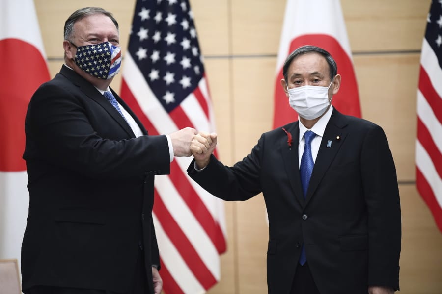 Japan&#039;s Prime Minister Yoshihide Suga, right, and U.S. Secretary of State Mike Pompeo, left, greet prior to their meeting at the prime minister&#039;s office in Tokyo, Tuesday, Oct. 6, 2020, ahead of the four Indo-Pacific nations&#039; foreign ministers meeting.