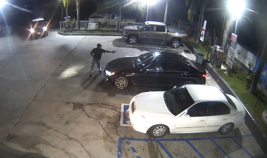 This Wednesday, Oct. 14, 2020, video image released by Los Angeles Police Department shows a moment captured on surveillance camera before an officer involved shooting in South Los Angeles. A man who pointed a gun at people in a South Los Angeles gas station parking lot was shot and killed by officers, the Los Angeles Police Department said. The shooting occurred late Wednesday after the armed man approached four people in the lot at 111th and Figueroa streets and officers on patrol saw the situation, the department said in a tweet.