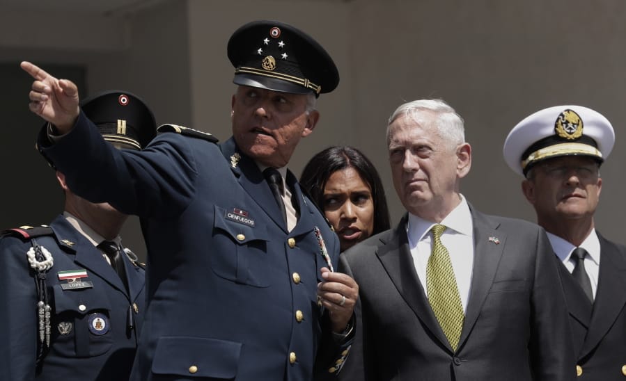 FILE - In this Friday, Sept. 15, 2017, file photo, Mexico&#039;s Defense Secretary Gen. Salvador Cienfuegos Zepeda gestures as U.S. Defense Secretary Jim Mattis listens during a reception ceremony in Mexico City. Mexico&#039;s top diplomat says the country&#039;s former defense secretary, Gen. Salvador Cienfuegos, has been arrested in Los Angeles. Foreign Relations Secretary Marcelo Ebrard wrote Thursday, Oct. 15, 2020 in his Twitter account that U.S. Ambassador Christopher Landau had informed him of Cienfuegos&#039; arrest.
