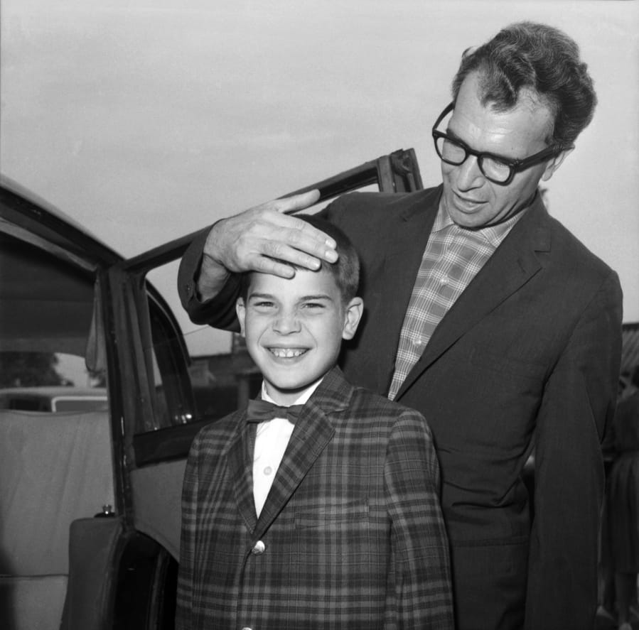 FILE - In this July 2, 1961, file photo, Dave Brubeck, the American Jazz musician, and his 13-year-old son Christopher, also a musician, arrive at London Airport, United Kingdom, from New York. Nearly eight years after his death, the final solo recording of late American jazz legend Dave Brubeck is set for release Nov. 6, 2020. Verve Records announced that &quot;Lullabies,&quot; a collection of intimate standards often played for children, will be available in the latest effort by a label to preserve unreleased jazz recordings.