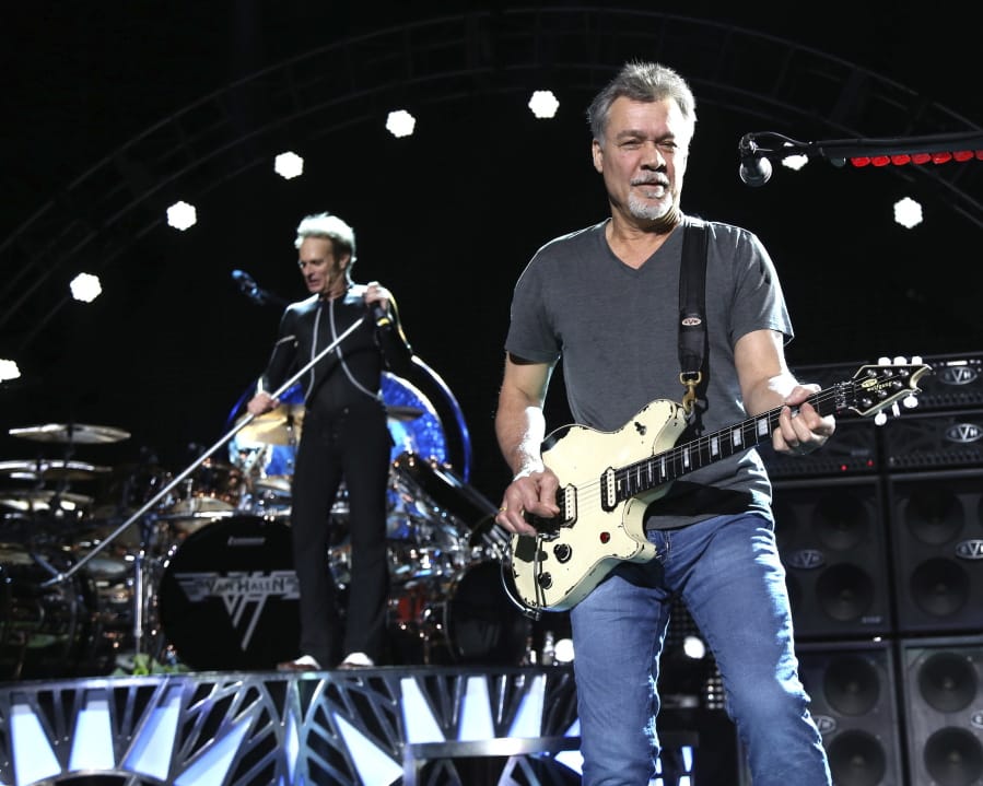 FILE - David Lee Roth, left, and Eddie Van Halen of Van Halen perform on Aug. 13, 2015, in Wantagh, N.Y. Van Halen, who had battled cancer, died Tuesday, Oct. 6, 2020. He was 65.
