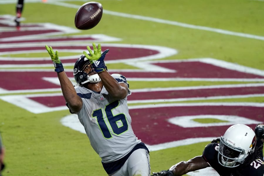 Seattle Seahawks wide receiver Tyler Lockett (16) pulls in a touchdown pass as Arizona Cardinals cornerback Dre Kirkpatrick (20) defends during the second half of an NFL football game, Sunday, Oct. 25, 2020, in Glendale, Ariz. (AP Photo/Ross D.