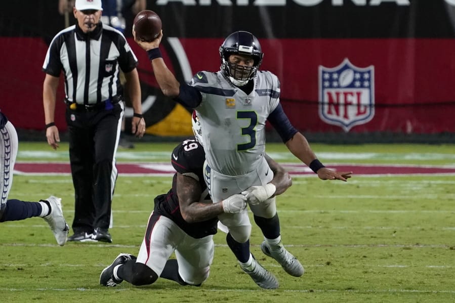 Seattle Seahawks quarterback Russell Wilson (3) gets the throw off as Arizona Cardinals linebacker Kylie Fitts makes the hit during the second half of an NFL football game, Sunday, Oct. 25, 2020, in Glendale, Ariz. (AP Photo/Rick Scuteri) (Associated Press/Ross D.
