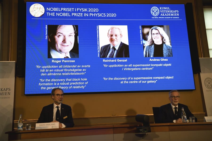 David Haviland, member of the Nobel Committee for Physics, left, and Goran K. Hansson, Secretary General of the Academy of Sciences, announce the winners of the 2020 Nobel Prize in Physics during a news conference at the Royal Swedish Academy of Sciences, in Stockholm, Sweden, Tuesday Oct. 6, 2020. The three winners on the screen from left, Roger Penrose, Reinhard Genzel and Andrea Ghez have won this year&#039;s Nobel Prize in physics for black hole discoveries.