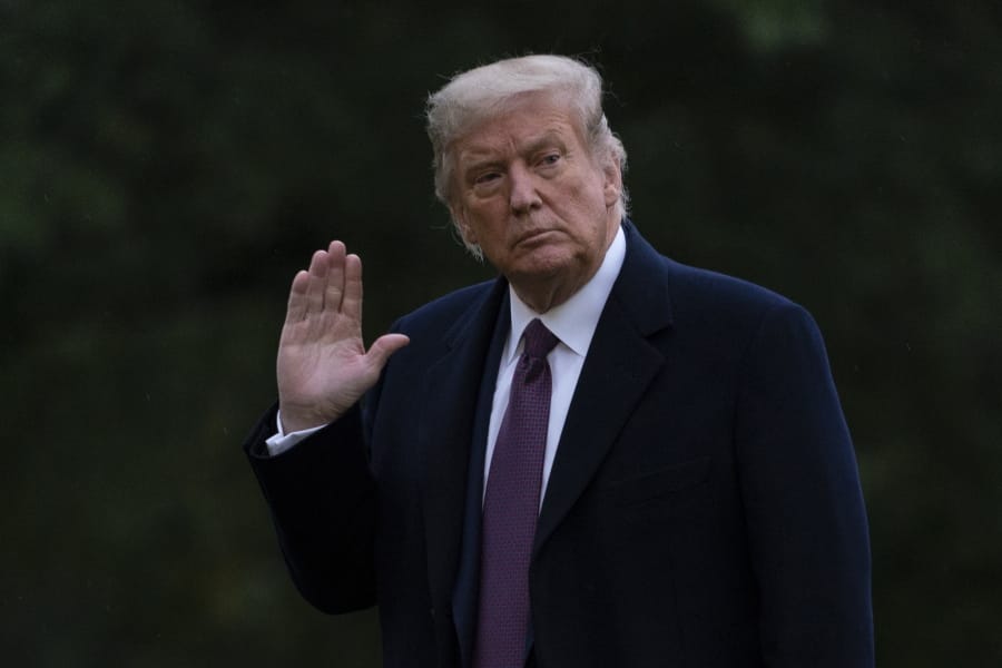 President Donald Trump waves as he walks from Marine One to the White House in Washington, Thursday, Oct. 1, 2020, as he returns from Bedminster, N.J. Trump and first lady Melania Trump have tested positive for the coronavirus, the president tweeted early Friday.