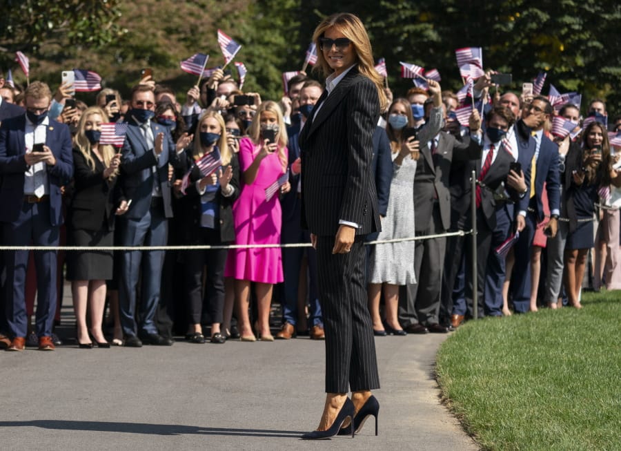 First lady Melania Trump pauses as she and President Donald Trump walk to board Marine One at the White House, Tuesday, Sept. 29, 2020, in Washington, for the short trip to Andrews Air Force Base en route to Cleveland for first debate against Democrat Joe Biden.