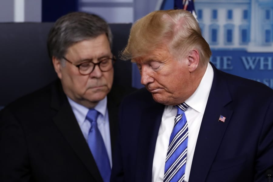 President Donald Trump moves from the podium arch 23 to allow Attorney General William Barr to speak about the coronavirus in the James Brady Briefing Room in Washington.