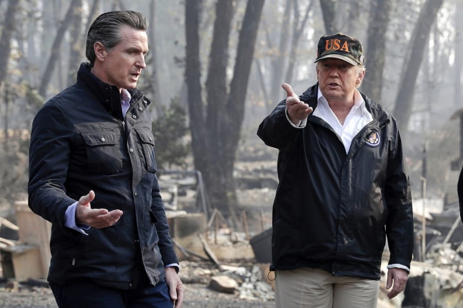 FILE - In this Nov. 17, 2018, file photo, President Donald Trump talks with then California Gov.-elect Gavin Newsom, left, during a visit to a neighborhood impacted by the wildfires in Paradise, Calif. Nearly two years ago President Trump ordered the U.S. Forest Service and the Department of Interior to make federal lands less susceptible to catastrophic wildfires. But the agencies fell short of his goals in 2019, treating a combined 4.3 million acres -- just over half of the 8.45 million acres the president sought. It was only slightly better than their average annual performance over nearly two decades, according to government data.