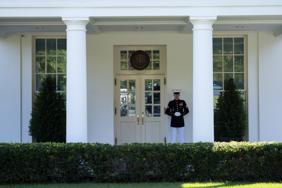 A Marine is posted outside the West Wing of the White House, signifying the President is in the Oval Office, Wednesday, Oct. 7, 2020, in Washington.