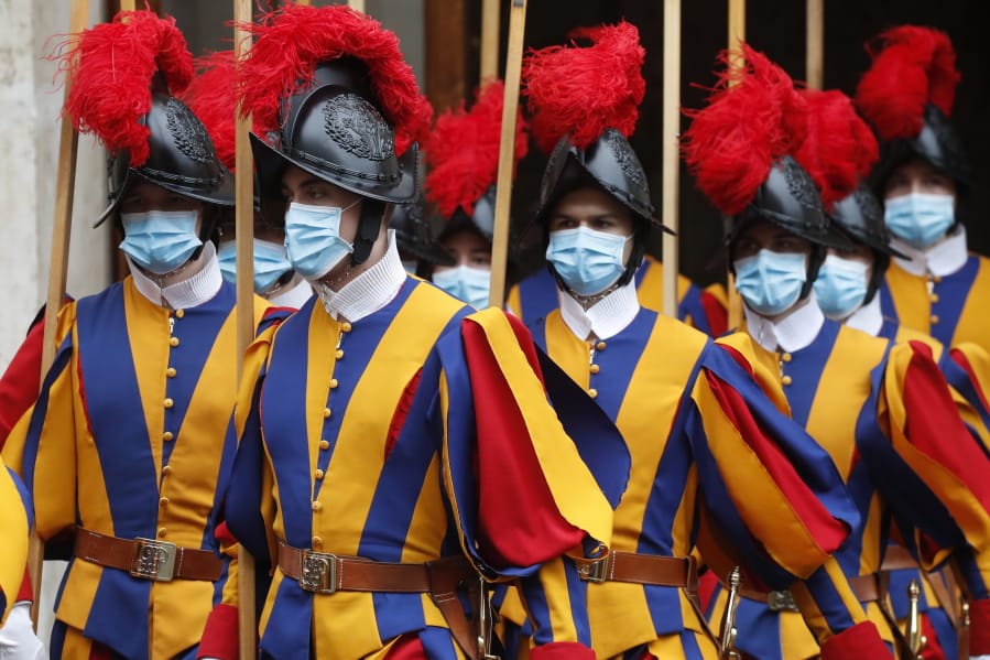 Vatican Swiss Guards, wearing masks to curb the spread of COVID-19, leave the St. Damaso courtyard after Spain&#039;s Prime Minister Pedro Sanchez meeting with Pope Francis, at the Vatican, Saturday, Oct. 24, 2020.